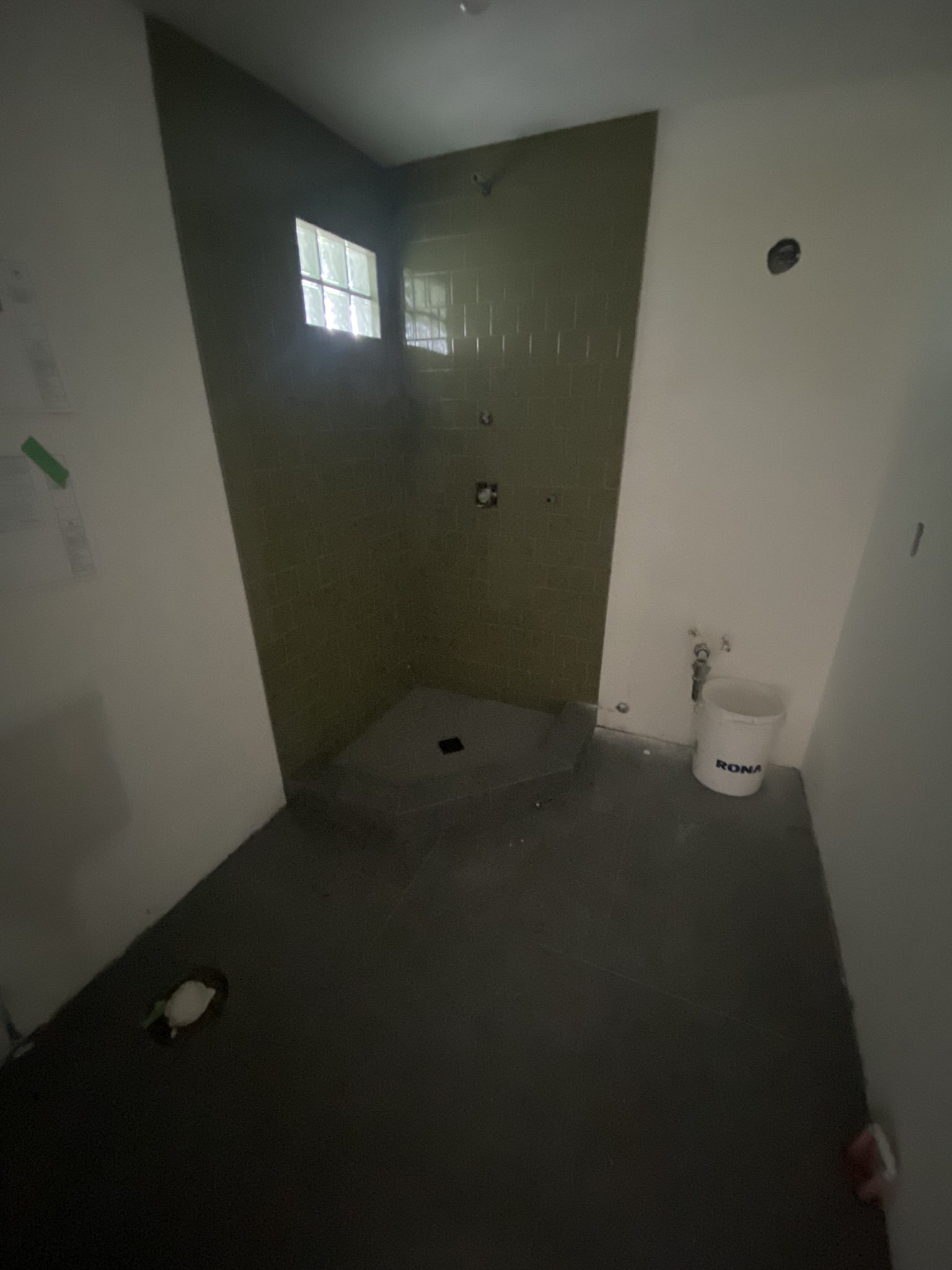 Olive green tile shower with curved pan