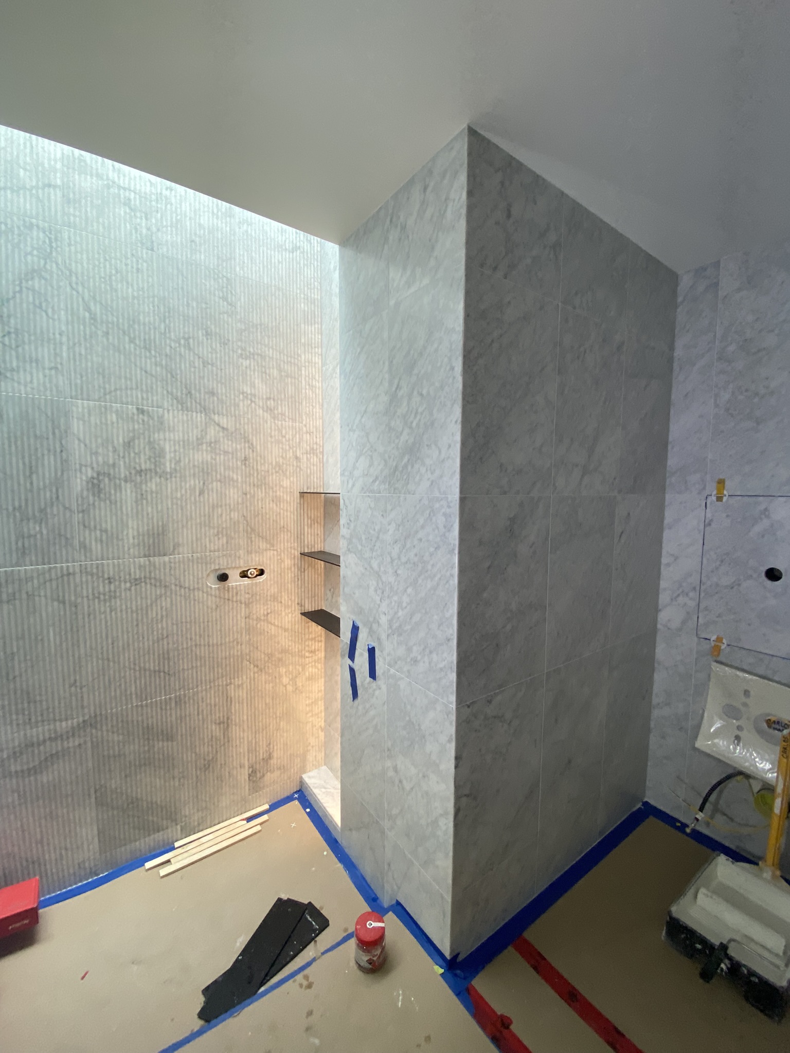 Marble shower with divider wall