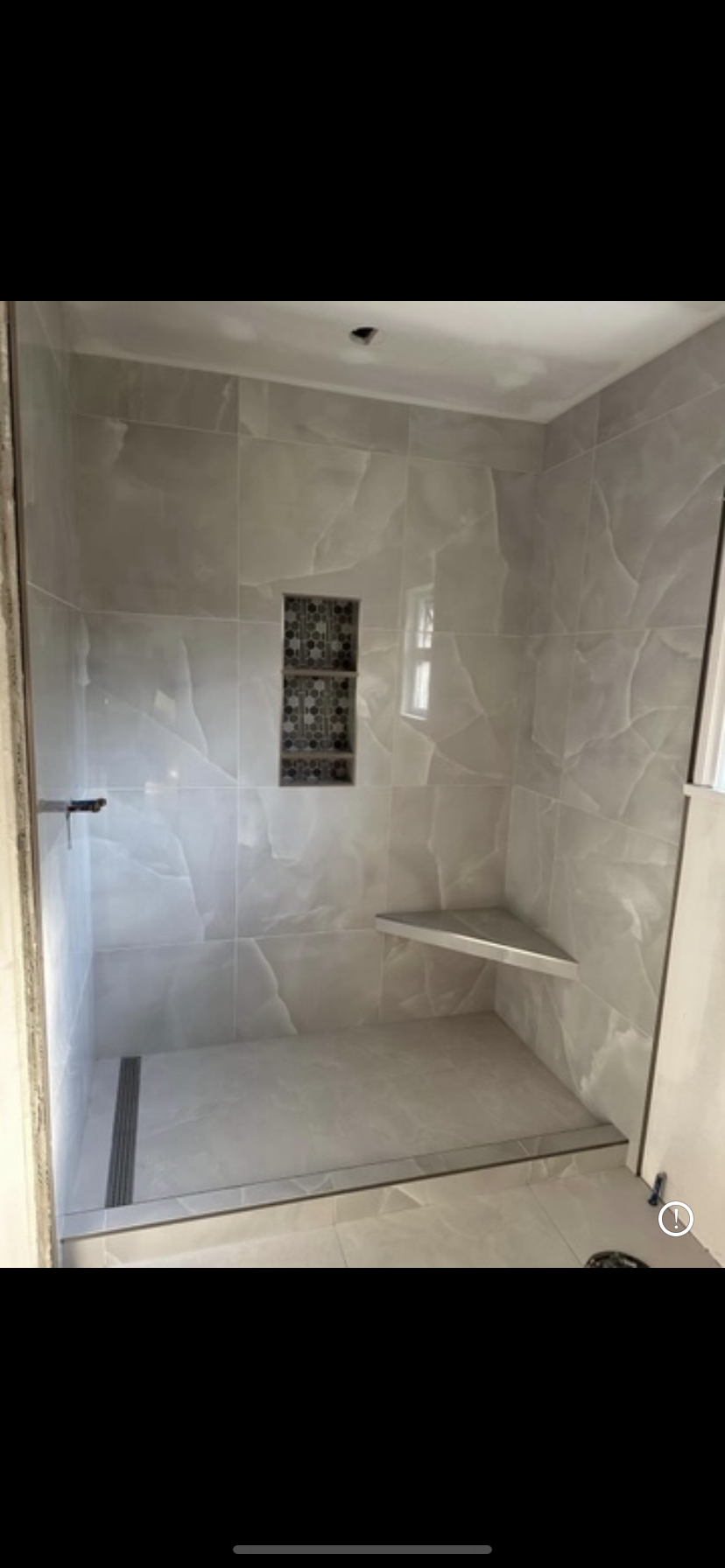Large format sculptured tile shower with mosaic niche