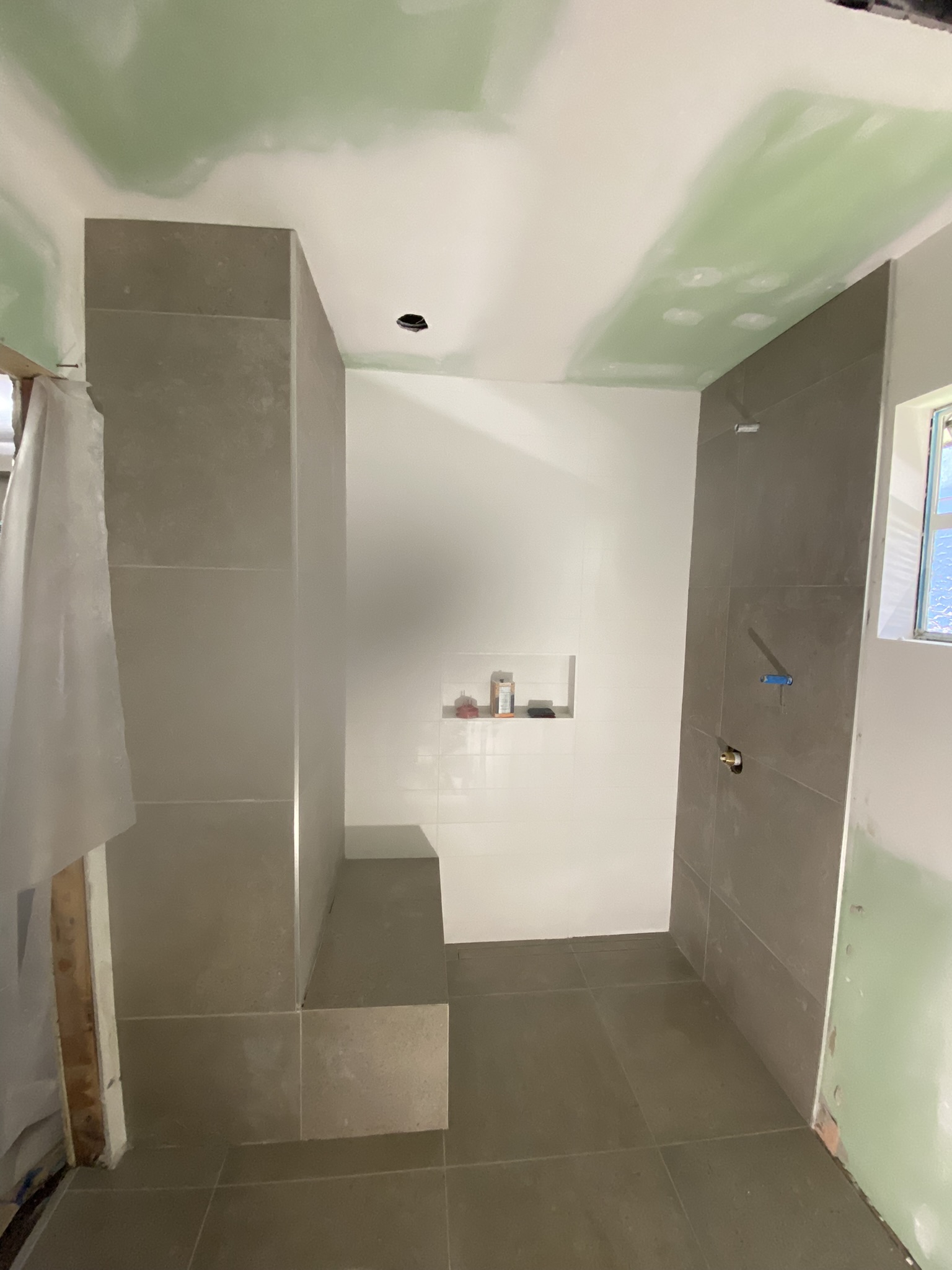 Large format tile floor installation in progress