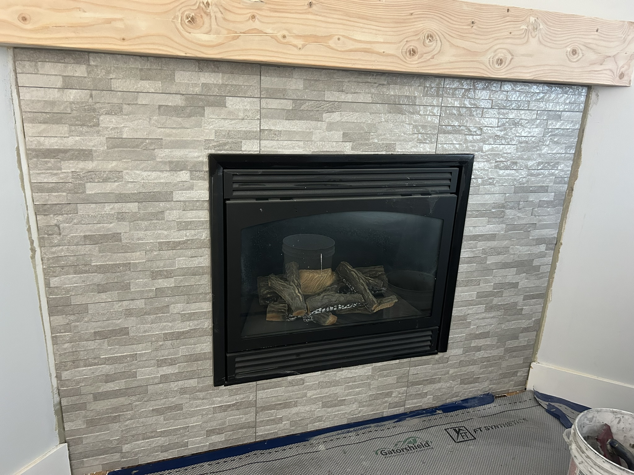 Grey stacked stone fireplace surround