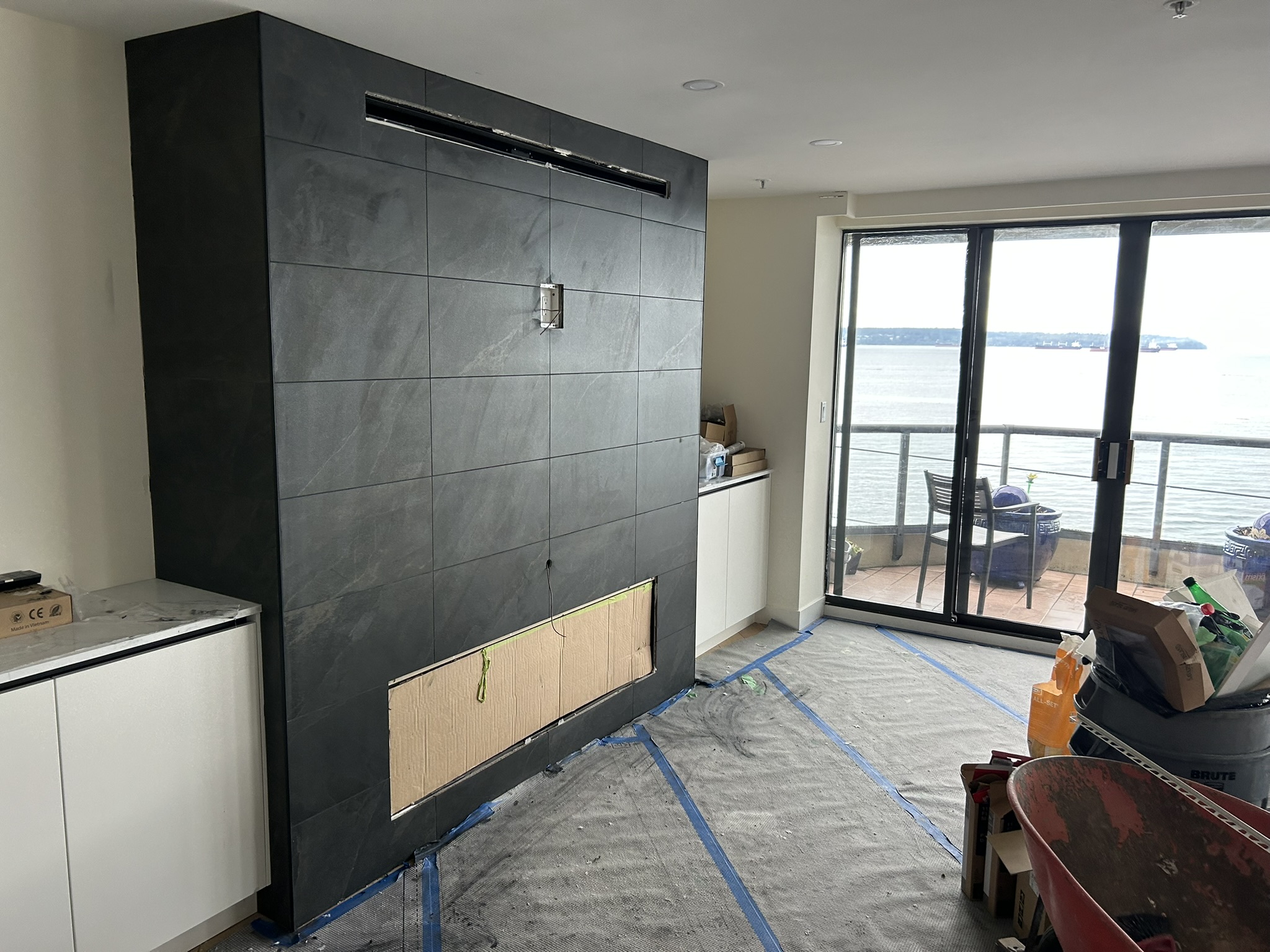 Floor to ceiling dark slate fireplace feature wall waterfront
