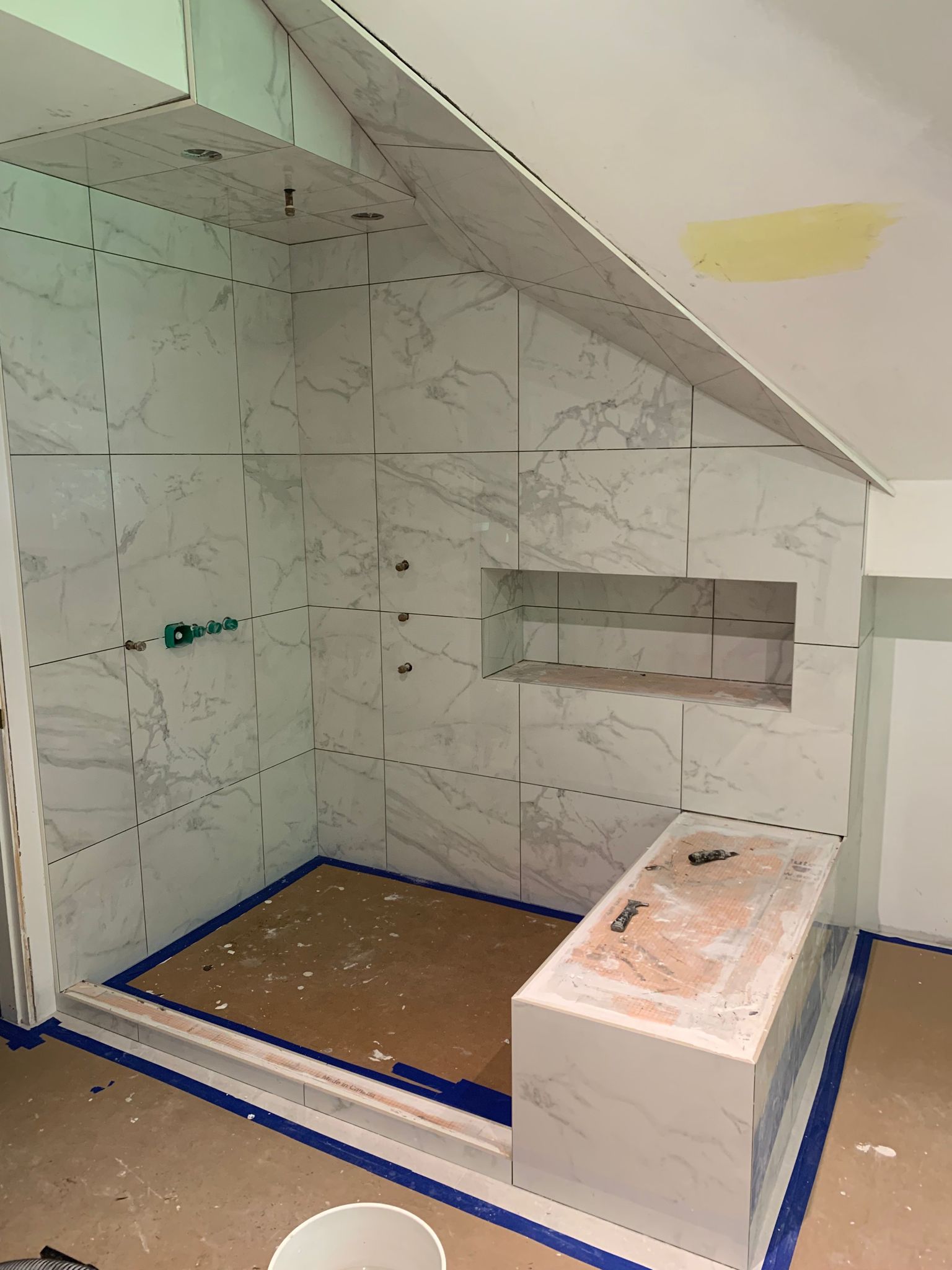 Vaulted ceiling shower with marble tile